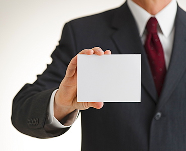 Businessman holding blank paper