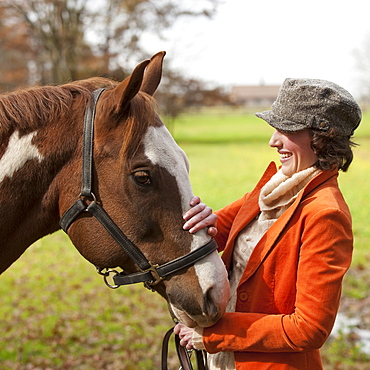 Woman petting horse