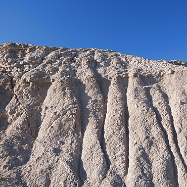 USA, South Dakota, Mountain against blue sky in Badlands National Park