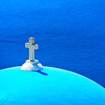 Greece, Cyclades Islands, Santorini, Oia, Church dome with cross by sea