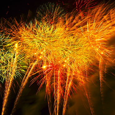 Fireworks explosion against night sky