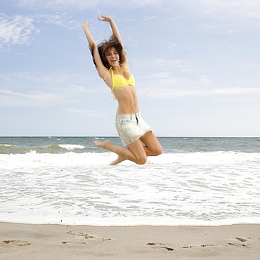 Woman jumping at beach