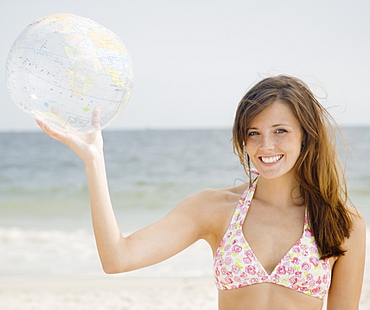 Woman holding inflatable globe