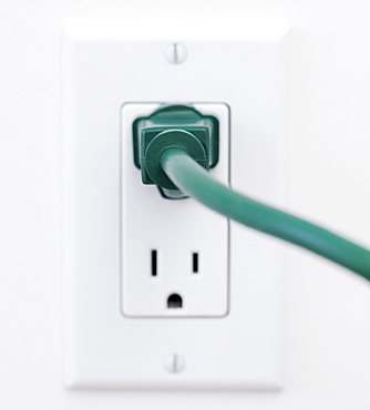 Close up of electric plug and wall outlet