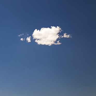 Single white cloud on blue sky