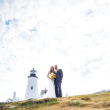 Portrait of married couple, lighthouse in background, USA, Maine, Bristol 