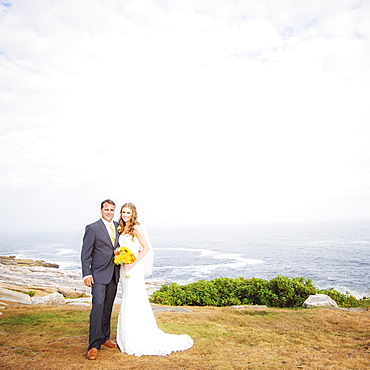 Portrait of married couple, sea in background, USA, Maine, Bristol 