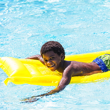 Portrait of boy ( 6-7) with pool raft