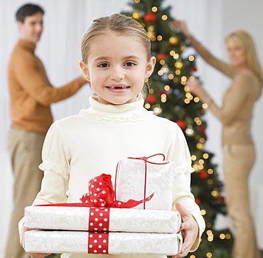 Portrait of girl holding gifts on Christmas