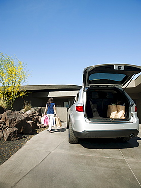 Car with open trunk with groceries, USA, Utah, St George