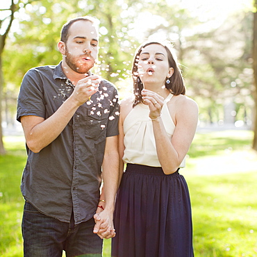 Happy young couple blowing bubbles, USA, Utah, Salt Lake