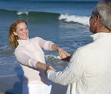 Couple holding hands at beach