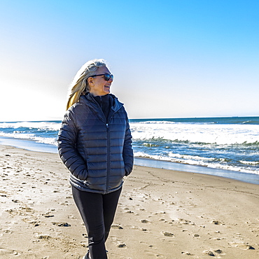 Mature woman walking on beach