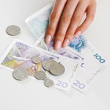 Close up studio shot of woman's hand and money