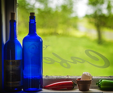 United Kingdom, England, Blue bottles on window sill