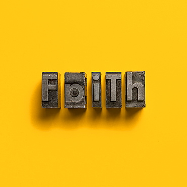 Wooden printer font letters spelling word Faith