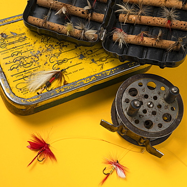 Vintage fishing tackle on yellow background