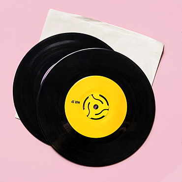 Vintage records on pink background