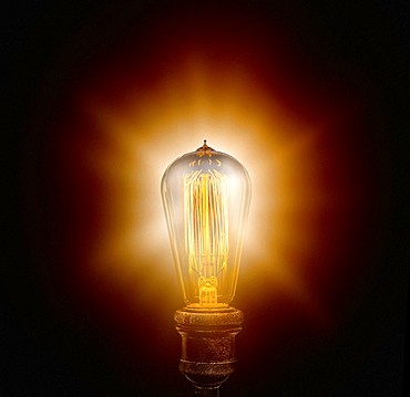 Edison light bulb on black background