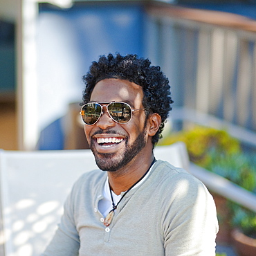 Black man in sunglasses smiling