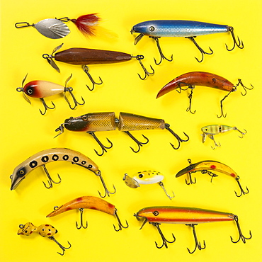 Retro fishing lures against yellow background