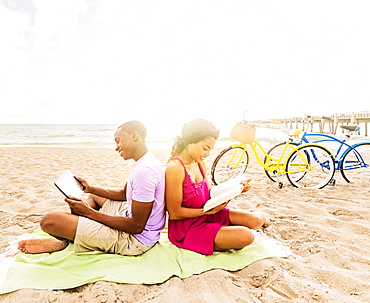 Young couple relaxing on beach, Jupiter, Florida