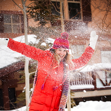 USA, Utah, Salt Lake City, Portrait of young woman playing in snow