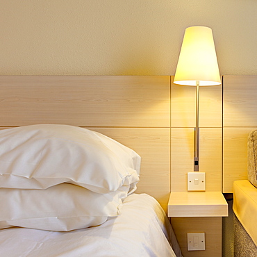 Electric lamp beside bed in luxury home