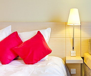 Electric lamp beside bed in luxury home