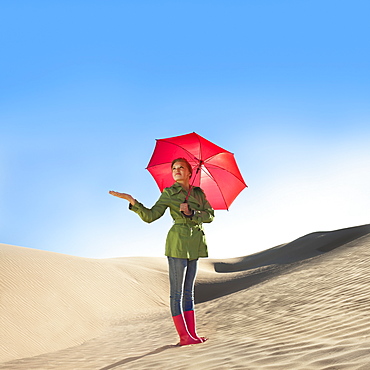 Woman waiting for rain in the desert