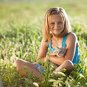 Young girl holding a kitten