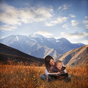 Mother and son reading outdoors