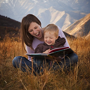 Mother and son reading outdoors