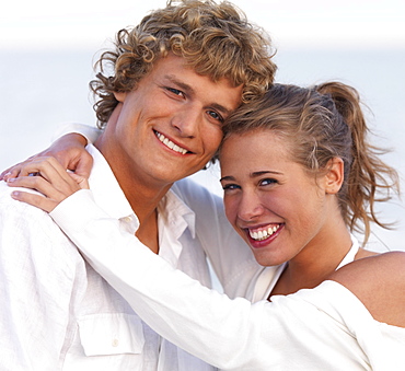 Young couple hugging on beach