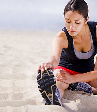 Runner stretching on beach