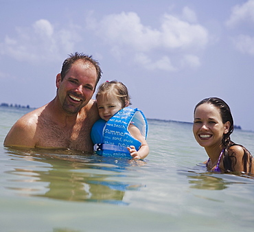 Parents and daughter in water, Florida, United States