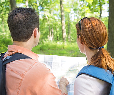 Couple hiking with map in forest, USA, New Jersey, Mendham