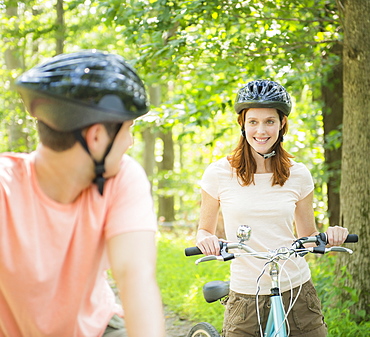 Couple cycling in forest, USA, New Jersey, Mendham