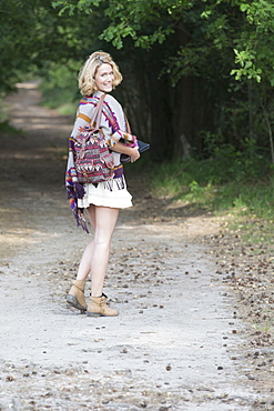 Woman walking dirt road, Netherlands, Gelderland, Hatertse Vennen