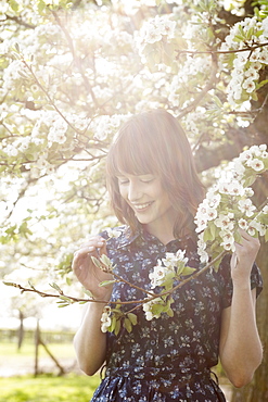 Portrait of young woman in spring orchard