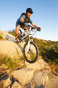 USA, California, Laguna Beach, Man cycling down hill