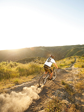 USA, California, Laguna Beach, Man cycling down hill