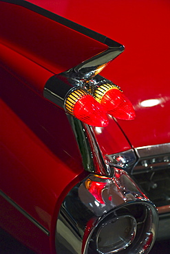 Tail fin on a 1959 red automobile