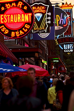 Crowd of people and Illuminated signs on Beale Street