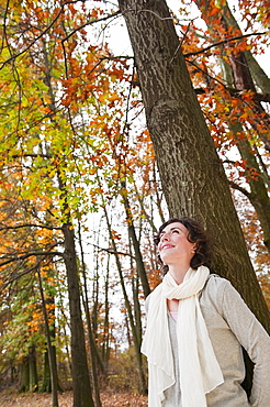 Woman leaning on tree