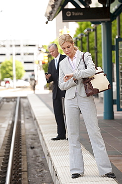 Two business people at a train station