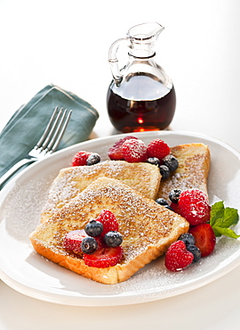 Studio shot of French toast with fruits and syrup