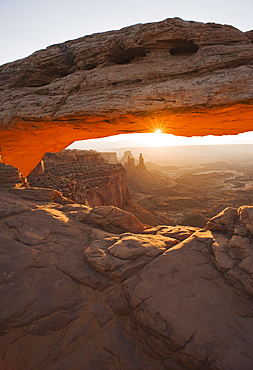 Sun shining behind Mesa Arch, Canyonlands National Park, Utah