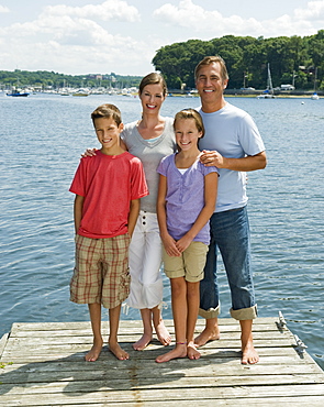 Family posing together on dock