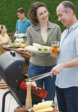 Family with two children barbecuing